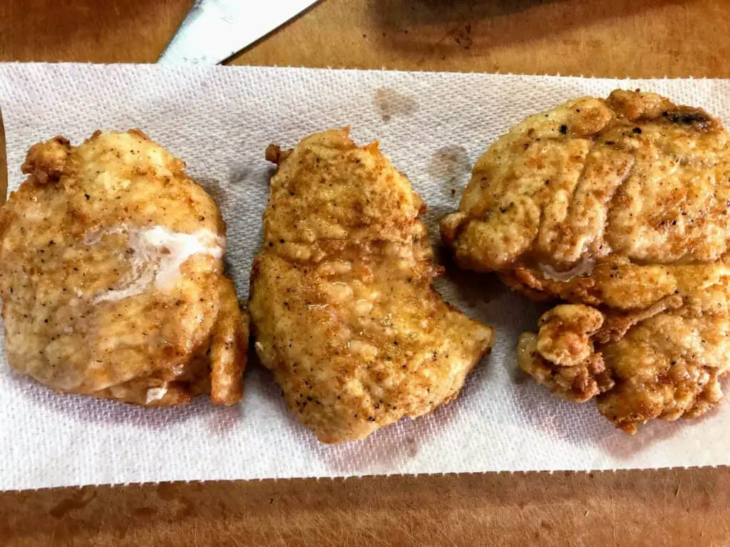 fried chicken breasts on cutting board