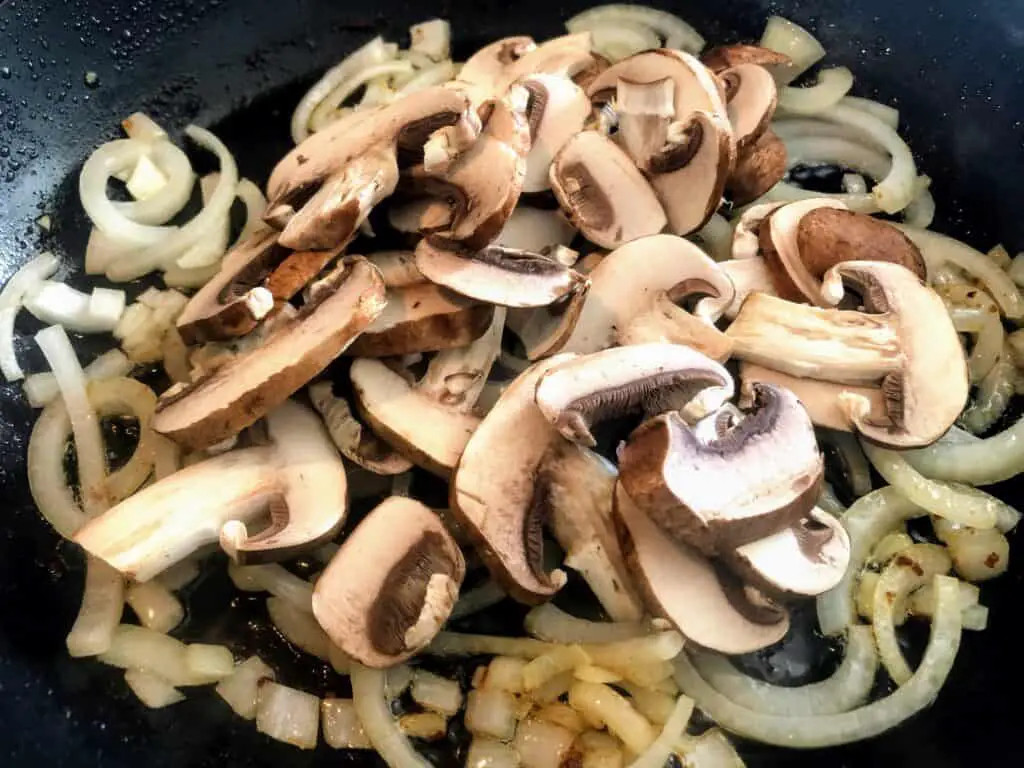 chopped onions and mushrooms in a pan