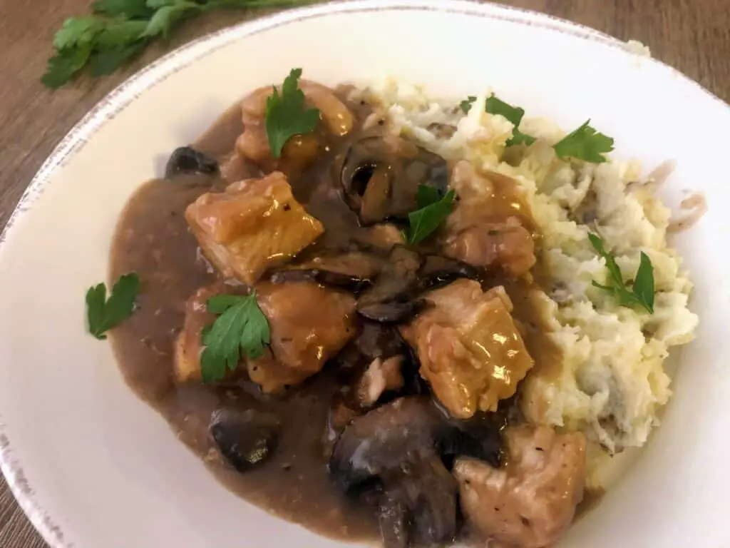 chicken marsala with mashed potatoes in a bowl
