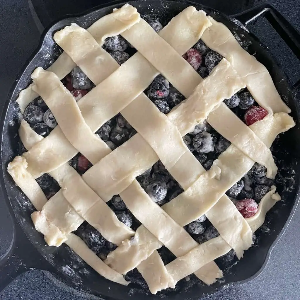 lattice crust over berries in a skillet